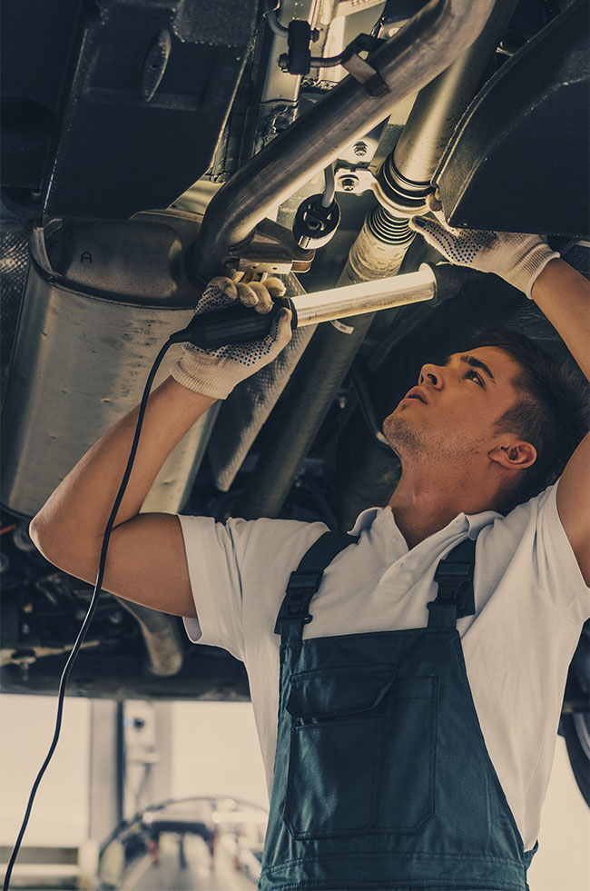 Mechanic looking under a vehicle - Servicing, Repairs, MOT's Glenrothes, Fife.